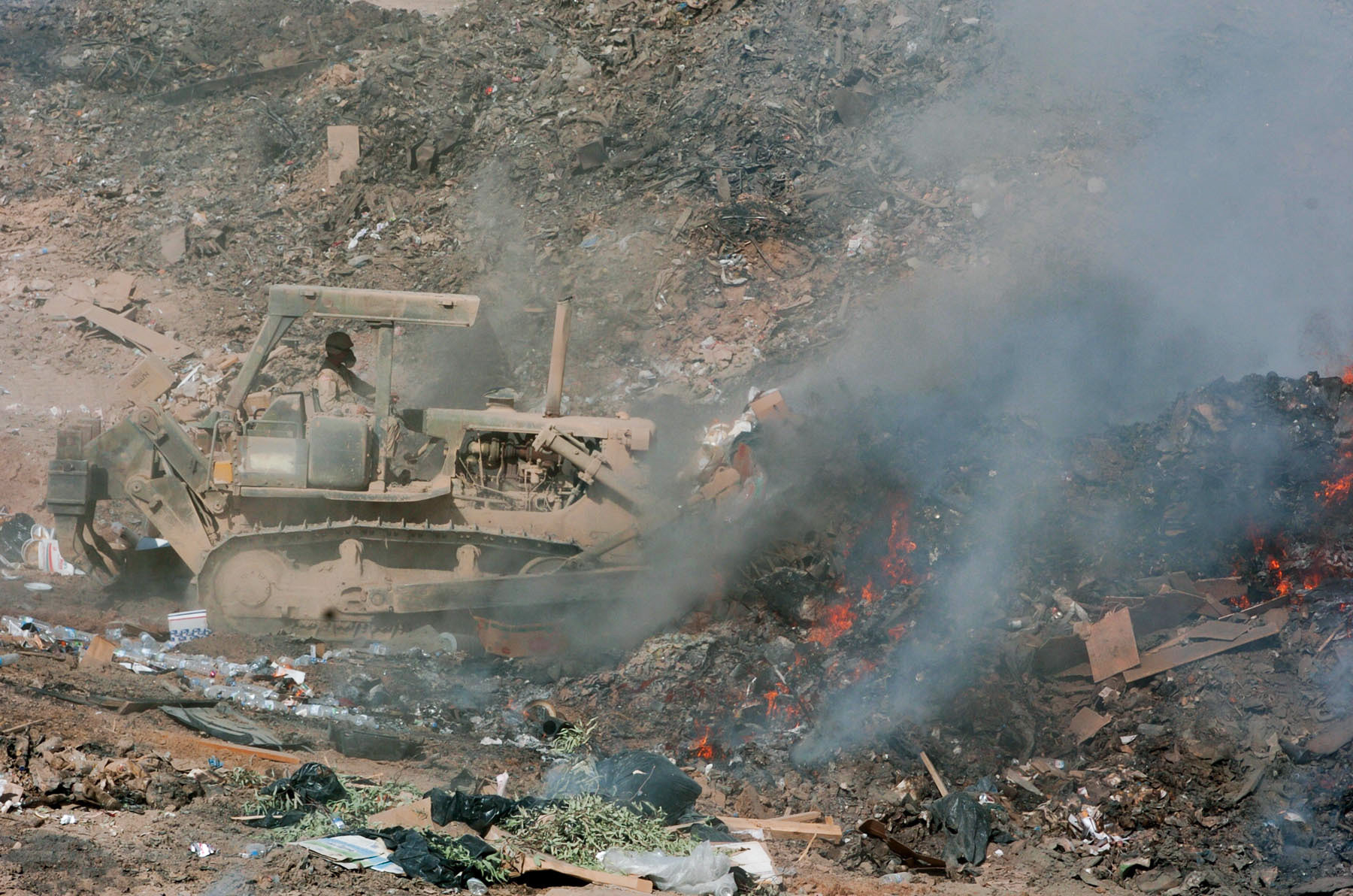 Balad, Iraq -  Bulldozer used to manuever refuse into the burn pit. (Photo Courtesy 28th Public Affairs Detachment)